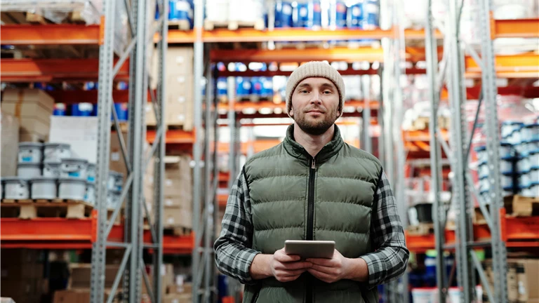 Man in Bubble Jacket Holding Tablet Computer